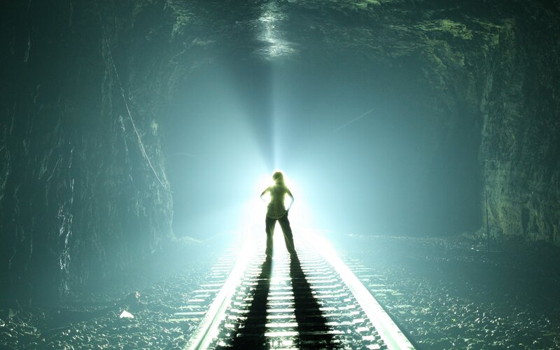 person in tunnel with light