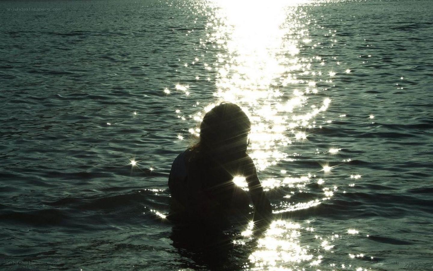 person in water at sunset