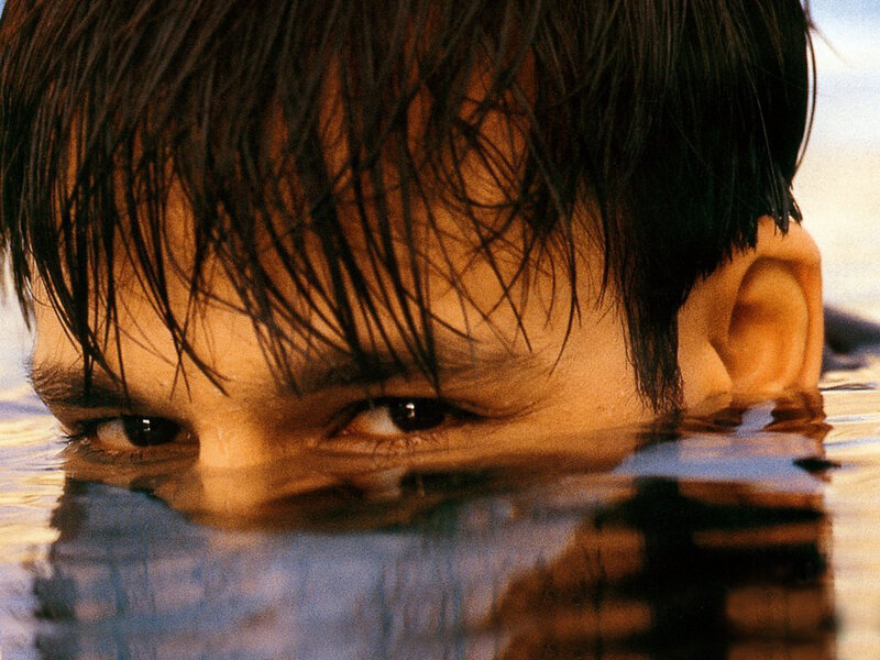 person in water with eyes visible