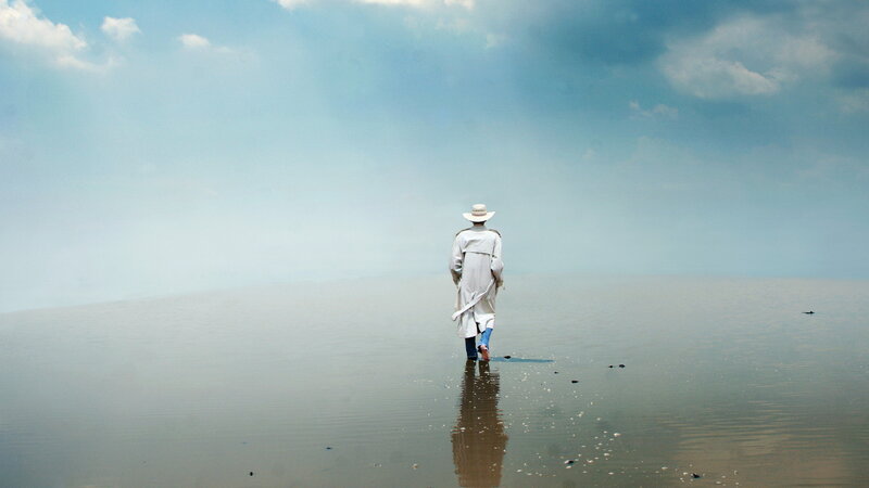 Person in White Coat — Blue, Serene