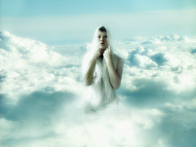 person in white dress among clouds