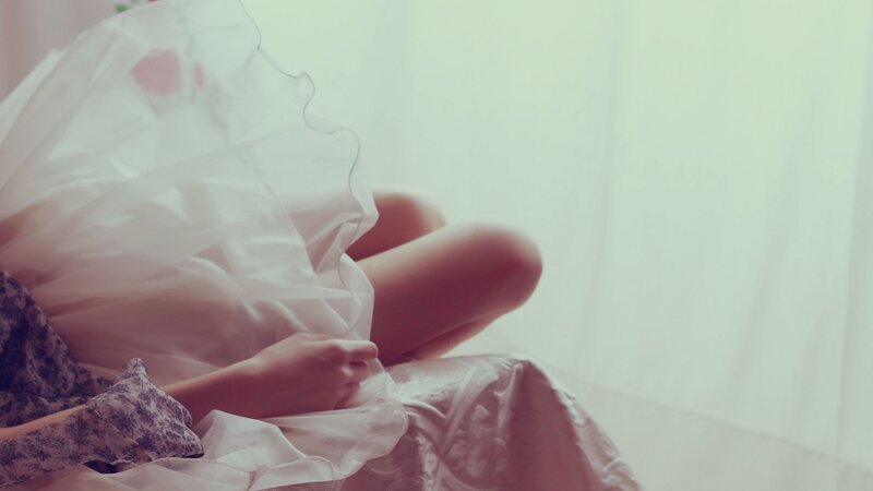 person in white dress sitting