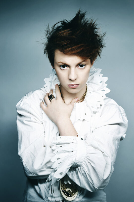 person in white ruffled shirt