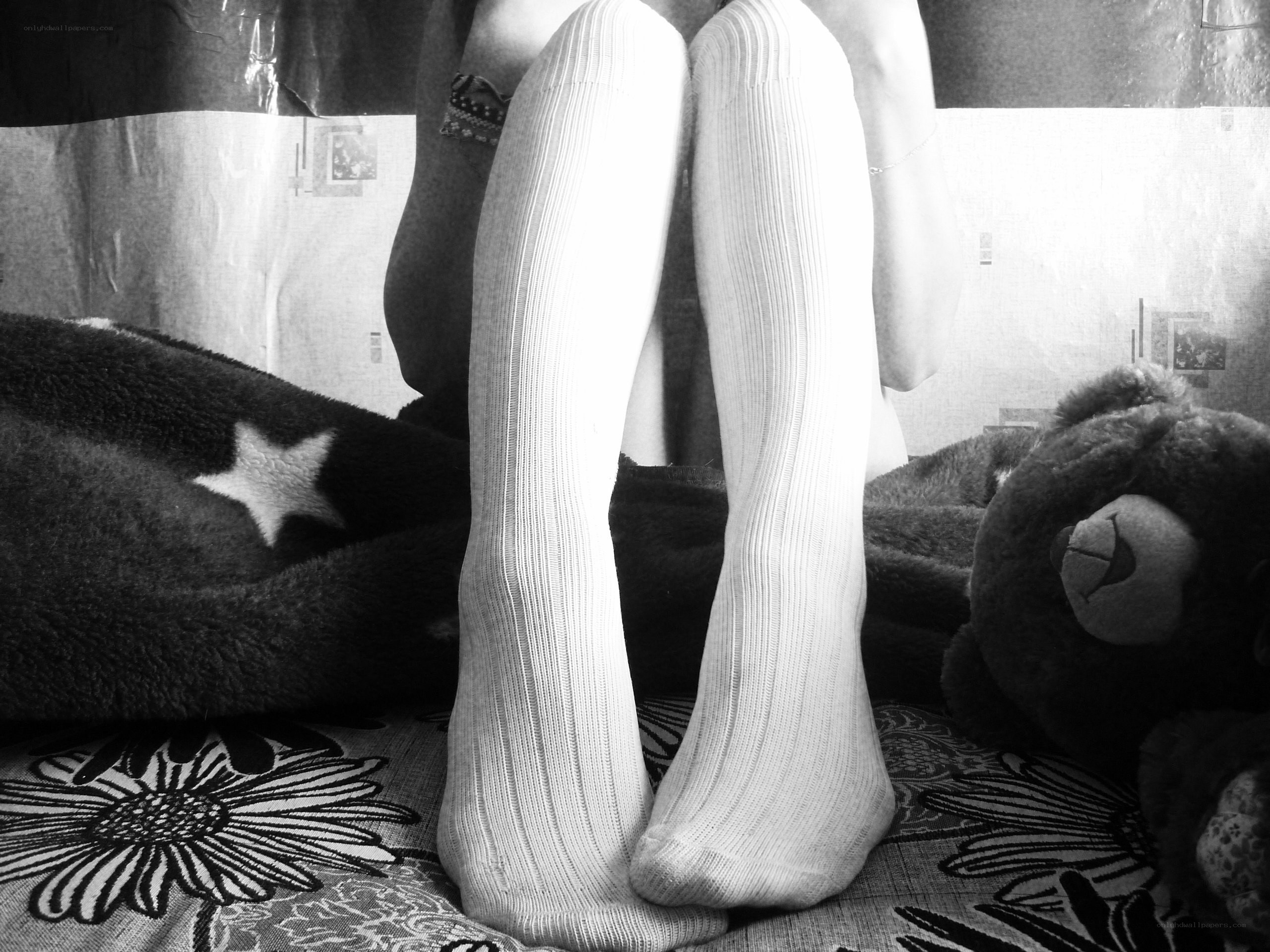 person in white socks on bed