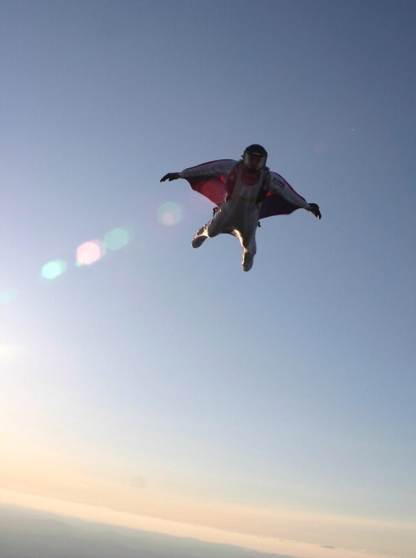 person in wingsuit flying