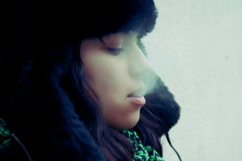 person in winter coat exhaling