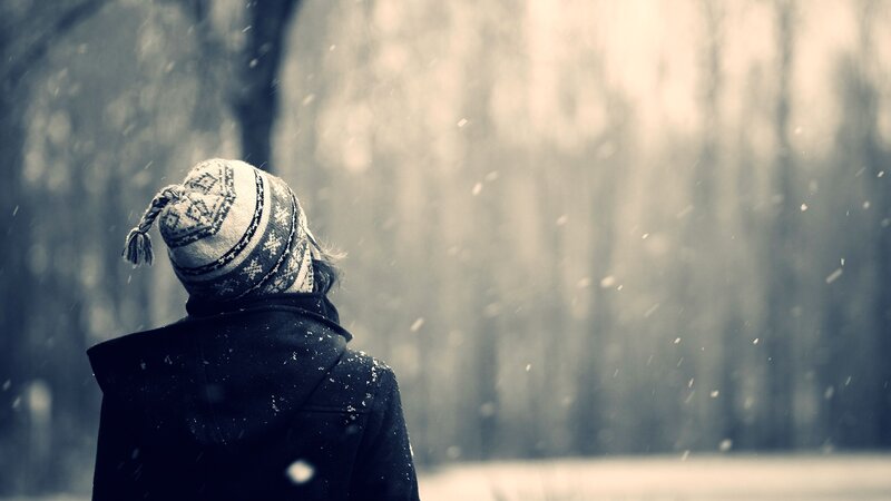 person in winter hat looking away