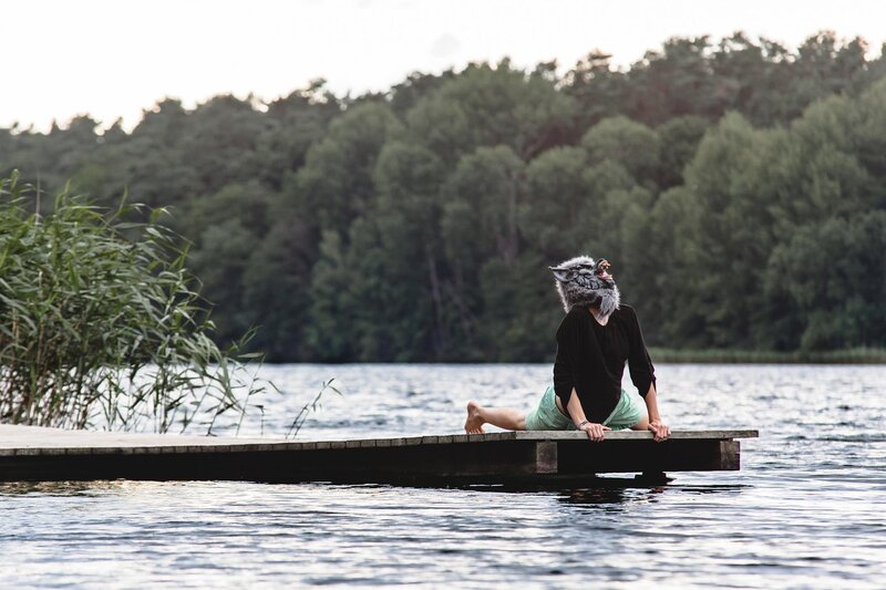 person in wolf mask on dock