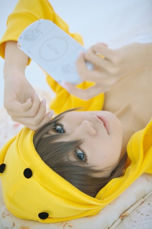 person in yellow costume holding device