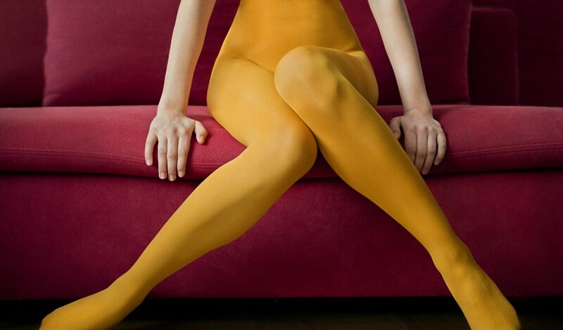 person in yellow tights on couch