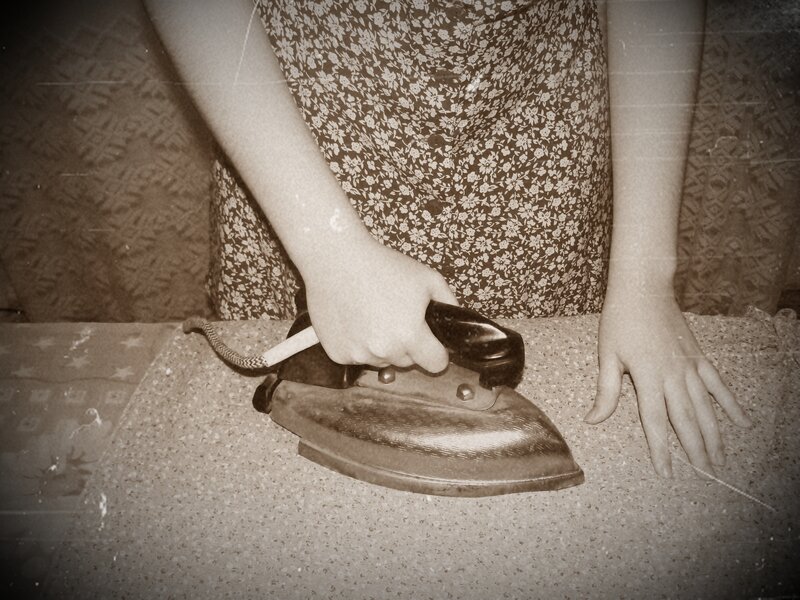 Person Ironing Clothes