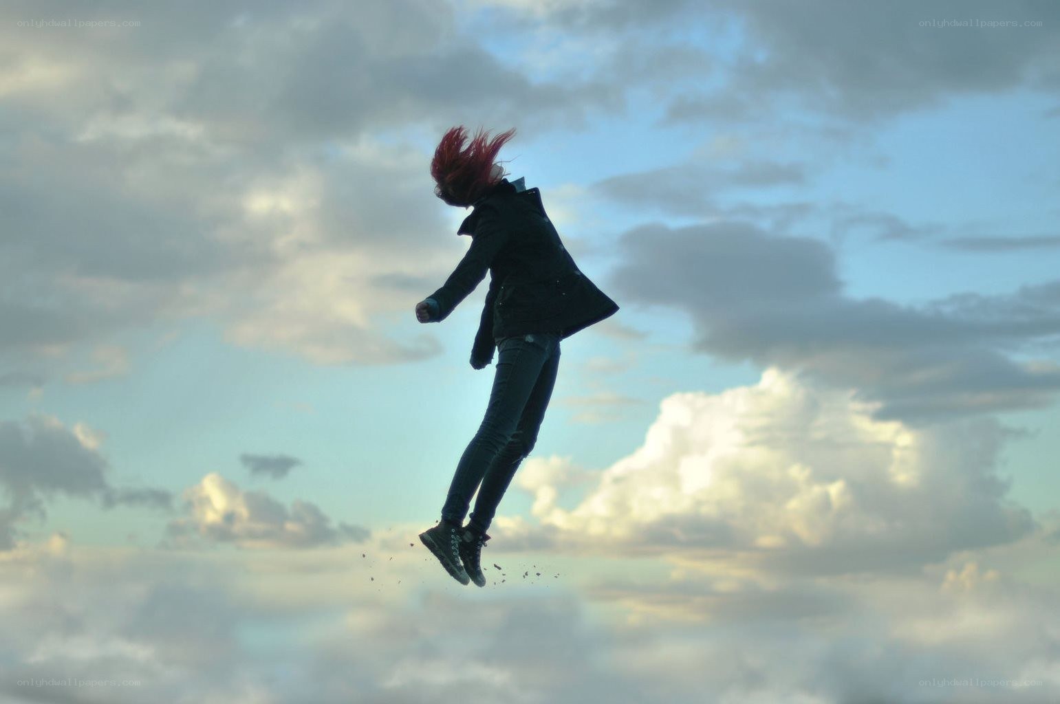 person jumping against sky