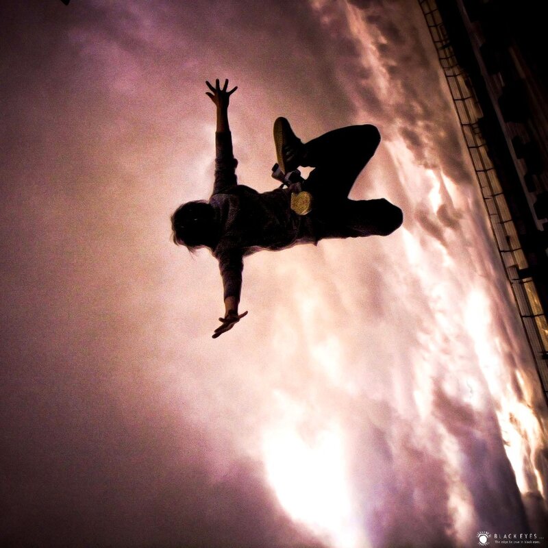 person jumping against sky