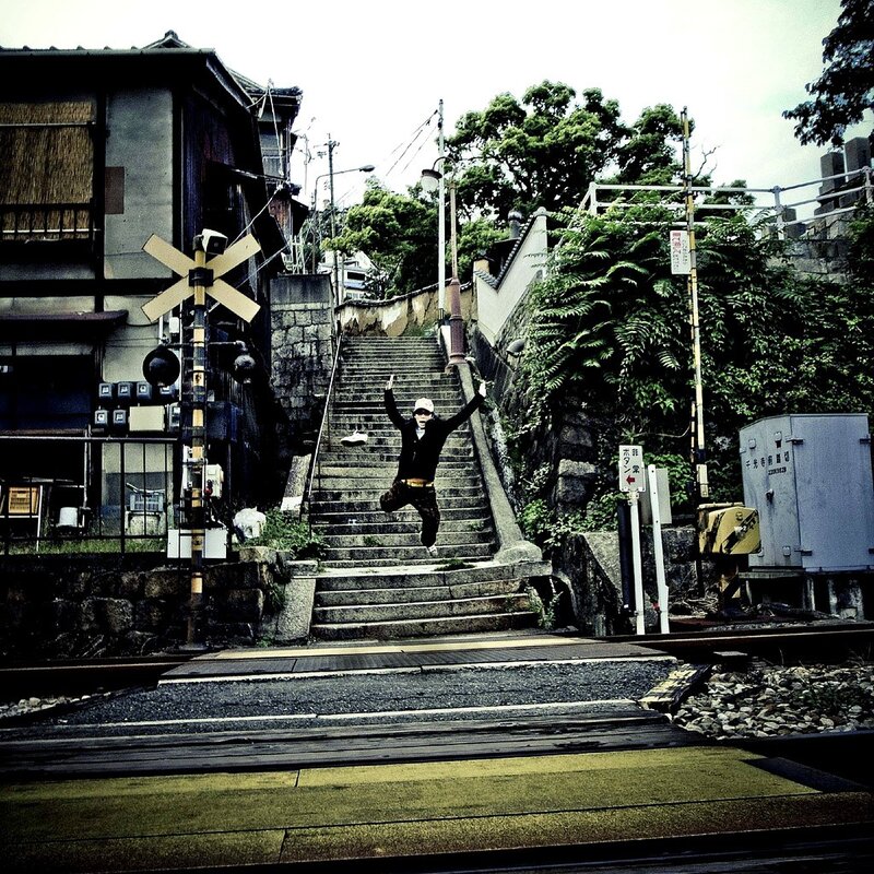 Person jumping at a railway crossing