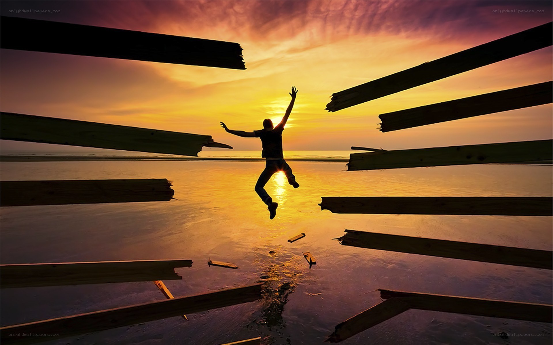 person jumping at sunset