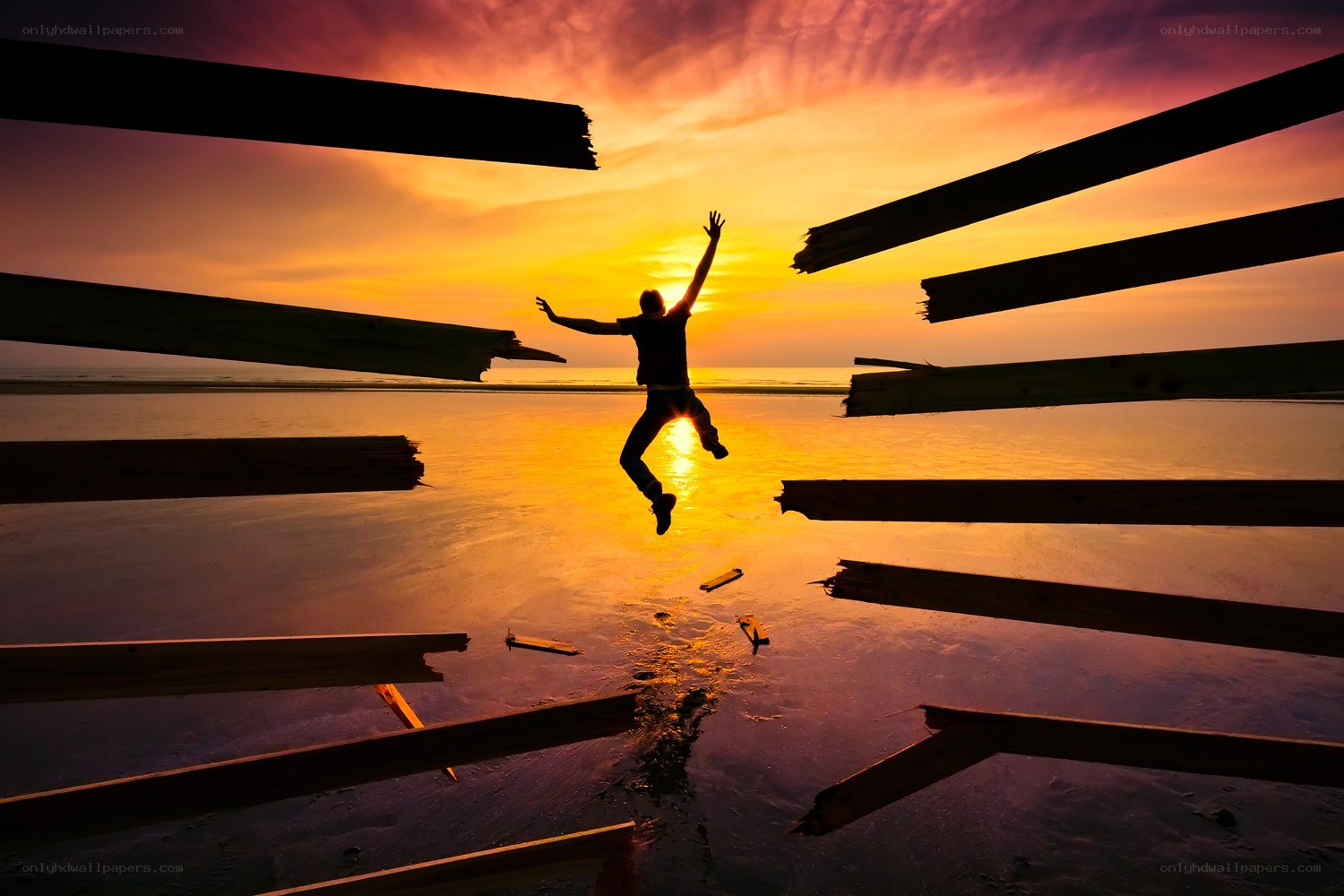 Person jumping at sunset