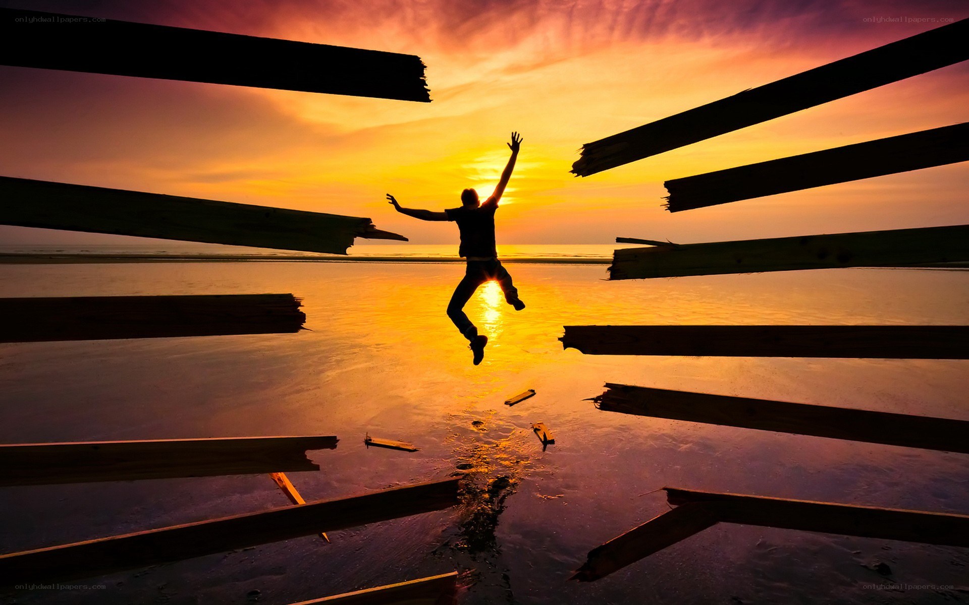 Person jumping at sunset