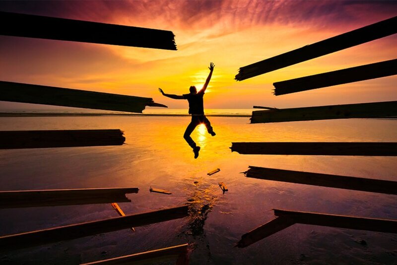 Person jumping at sunset