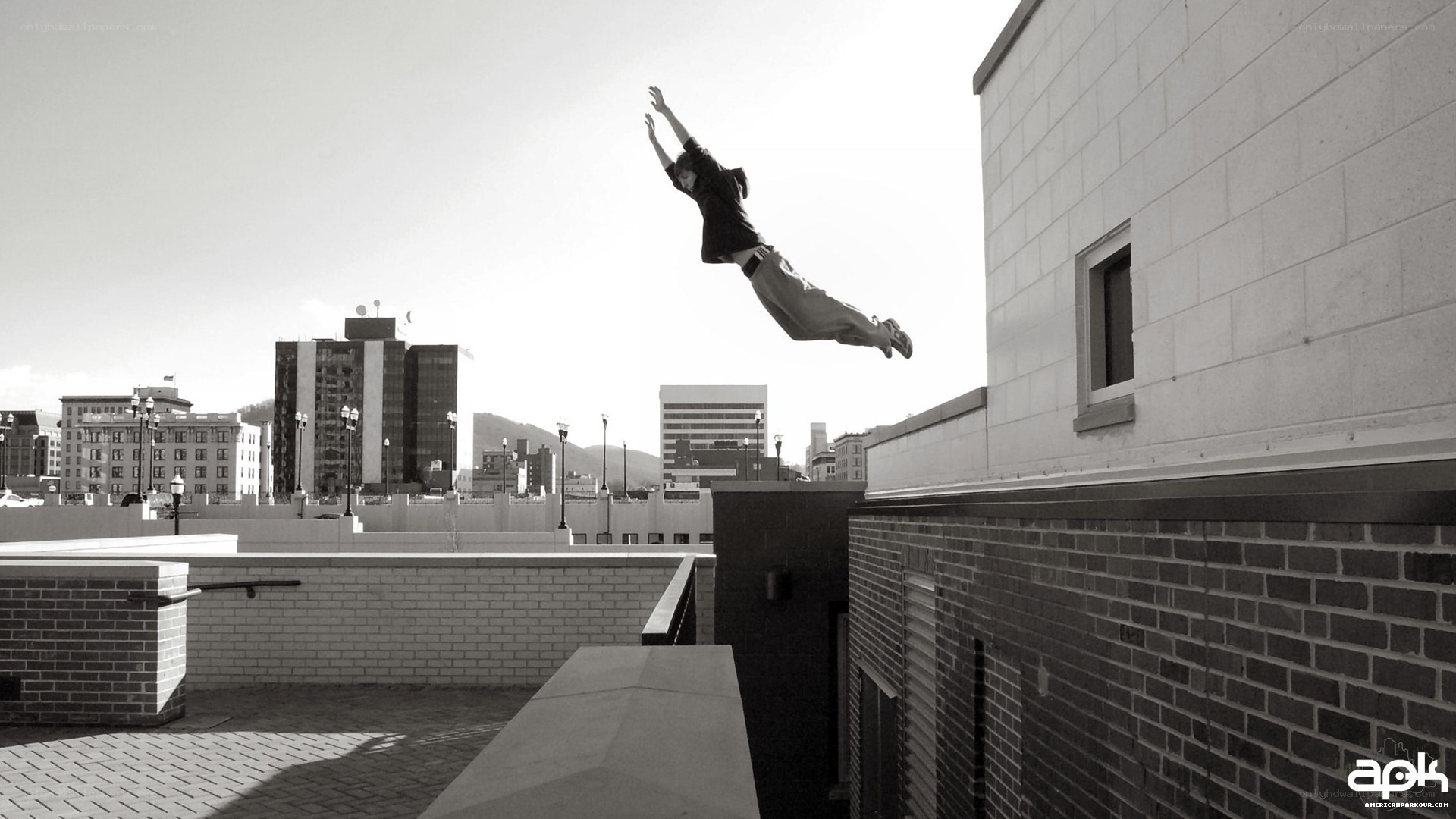 person jumping between buildings