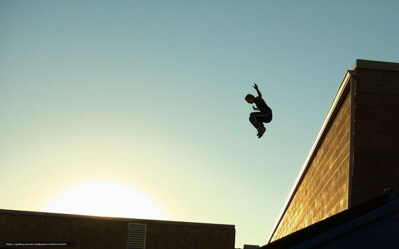 person jumping between buildings