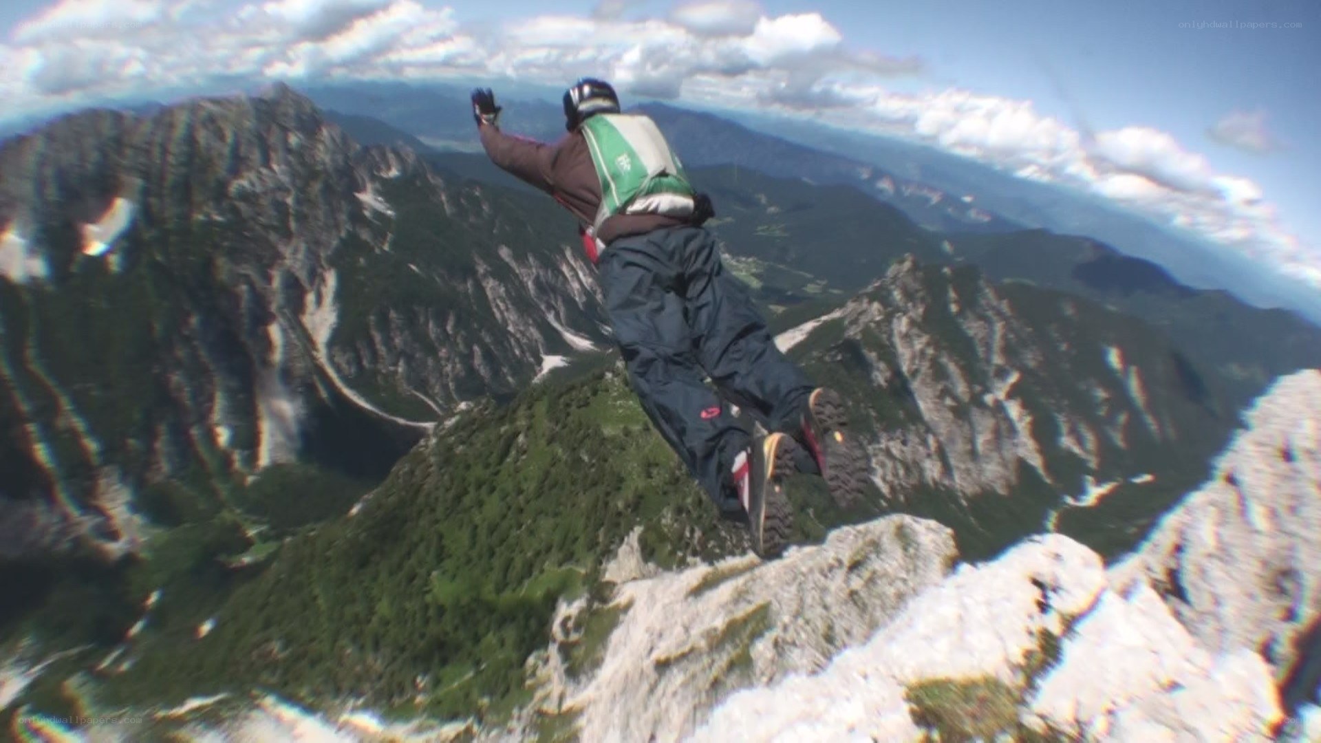 person jumping from mountain