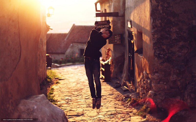 Person jumping in alley at sunset