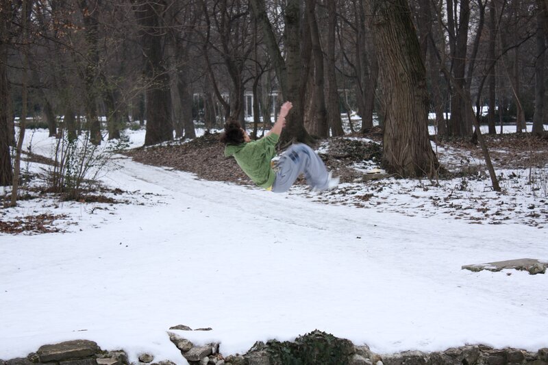 Person jumping in snowy park