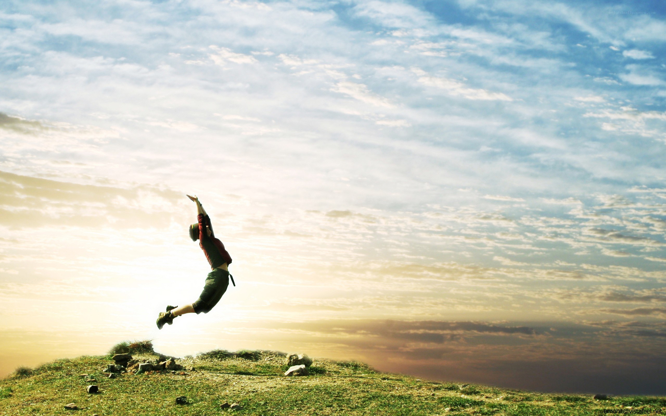 Person jumping on a hill