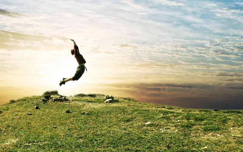 Person jumping on a hill