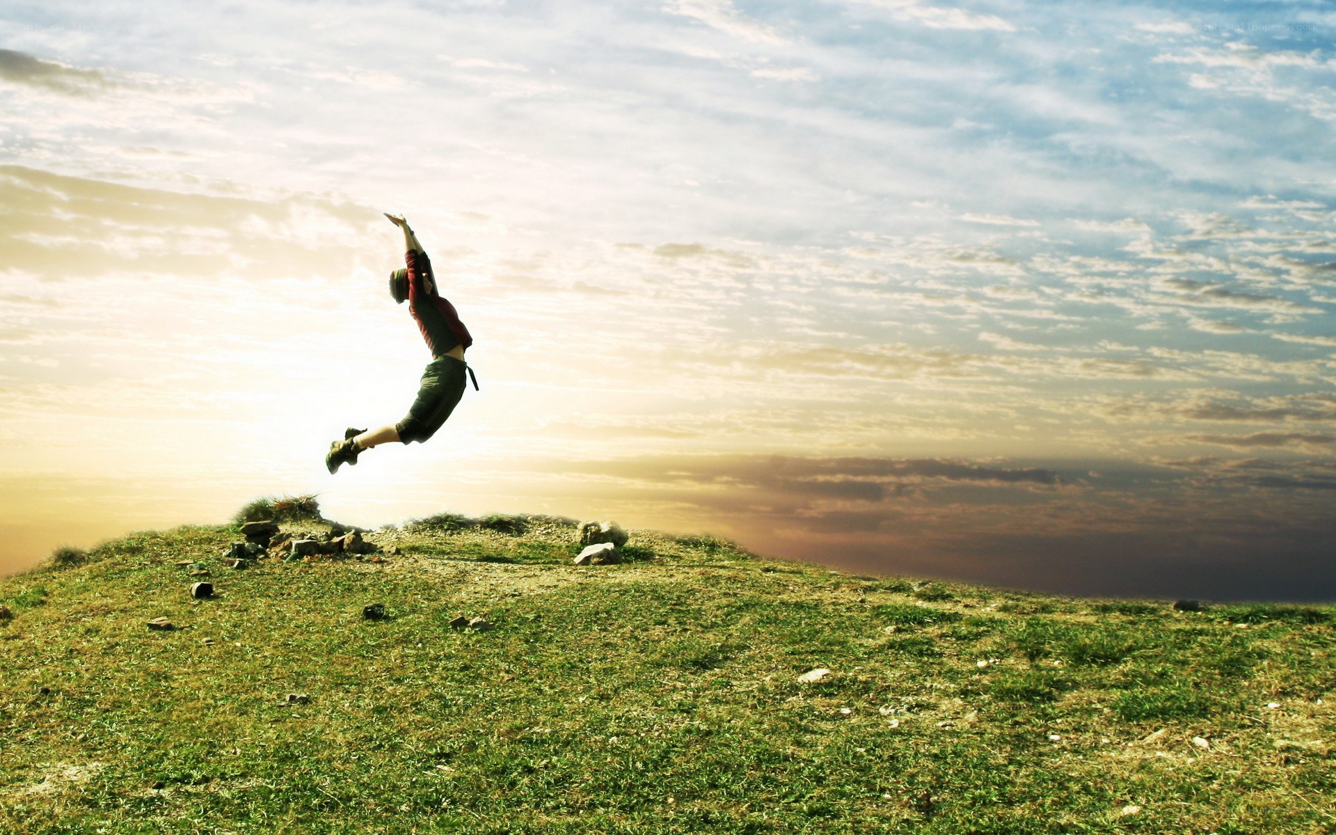 Person jumping on a hill