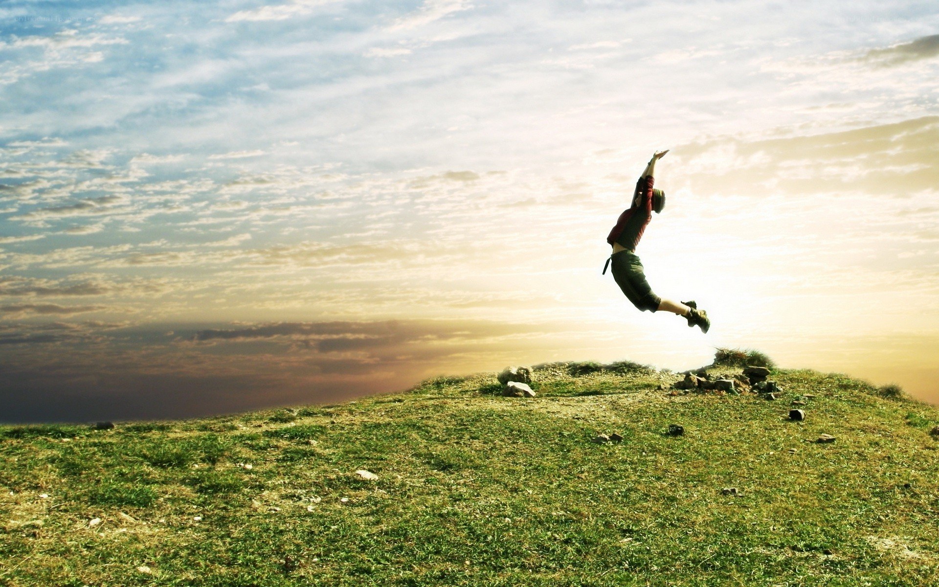 Person jumping on a hill