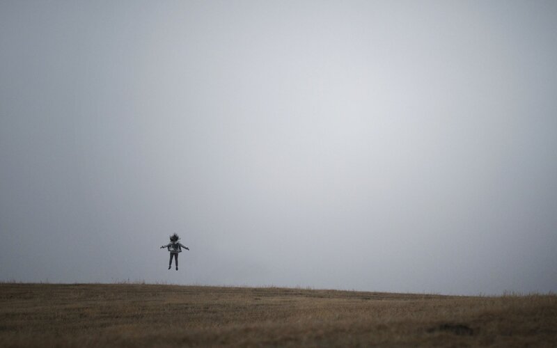 Person jumping on a hill
