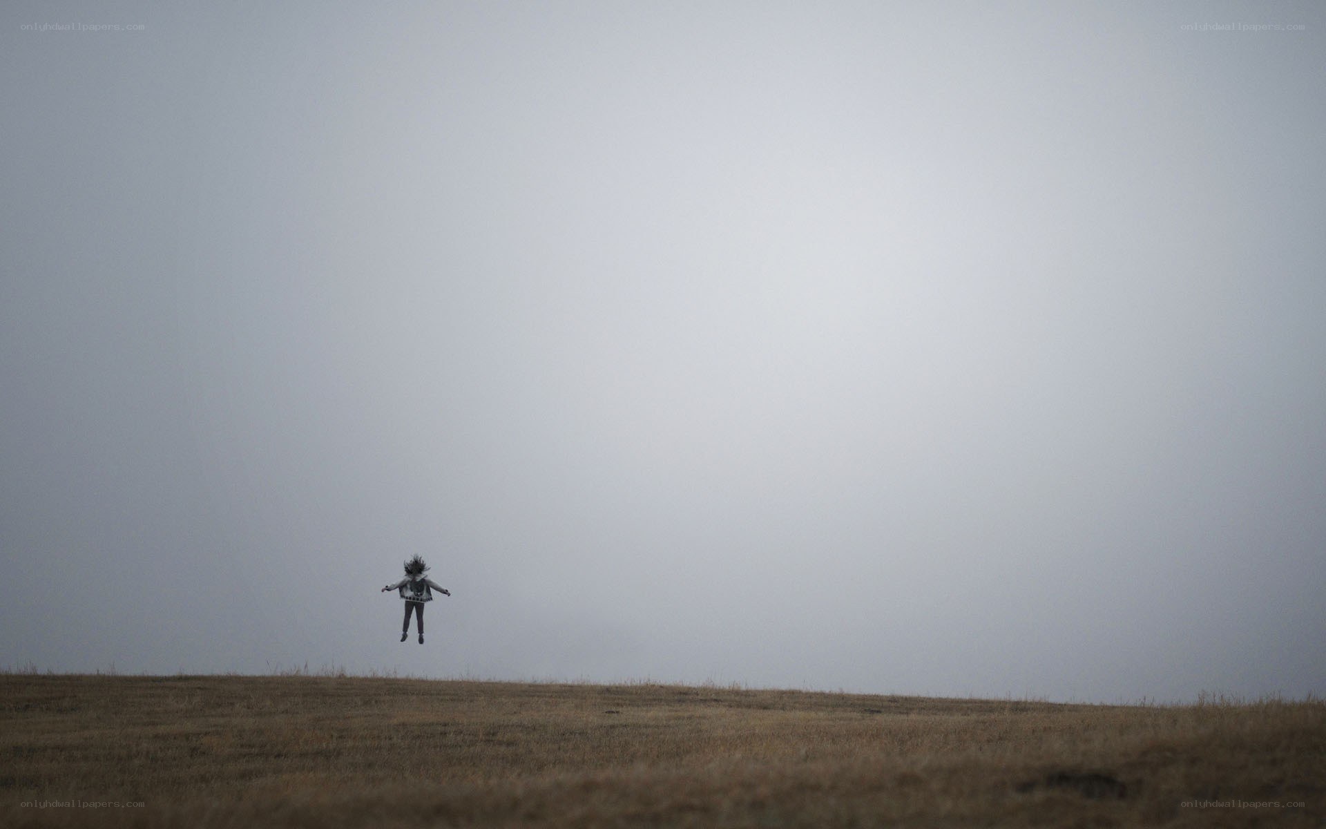 Person jumping on a hill