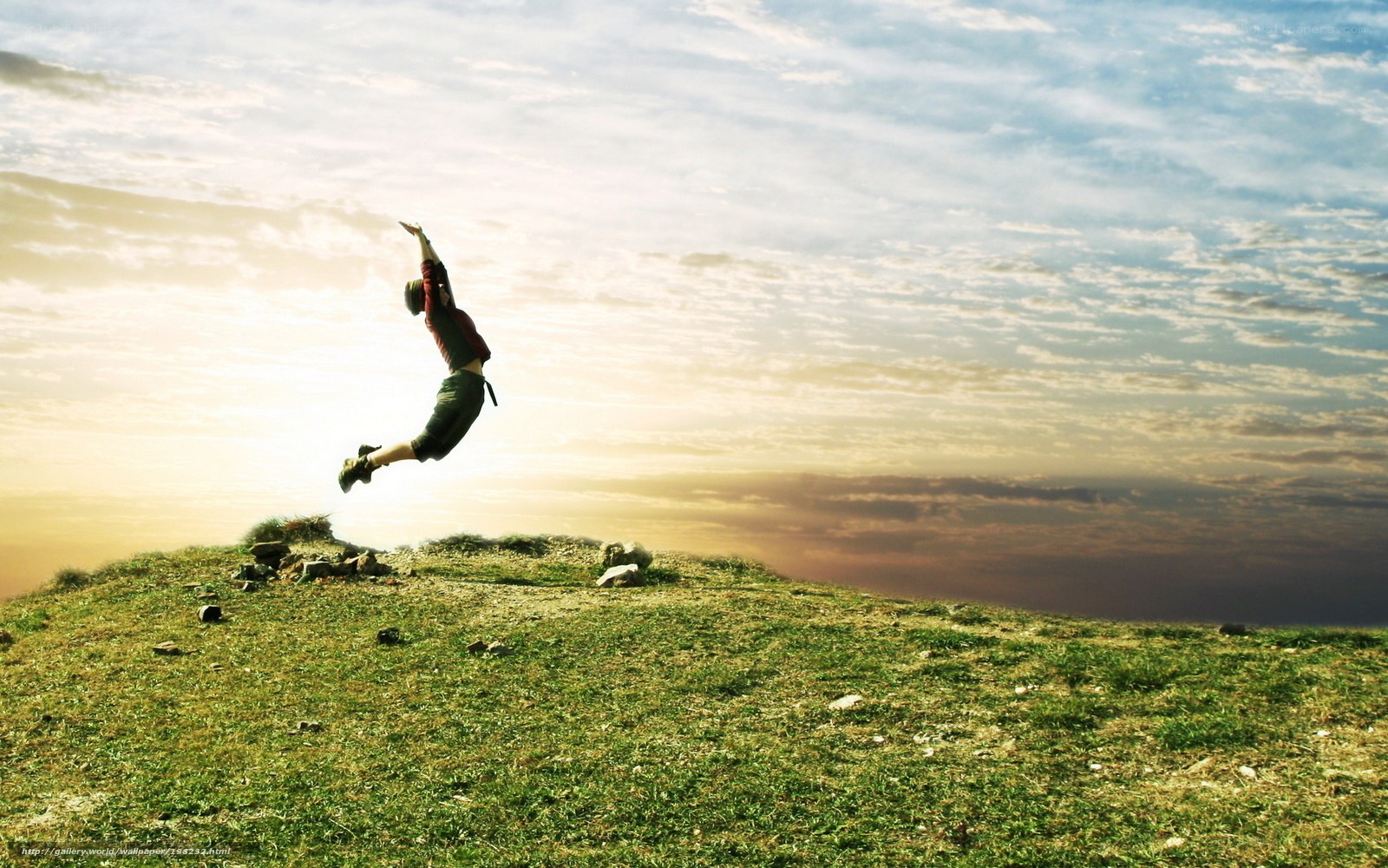 Person jumping on a hill