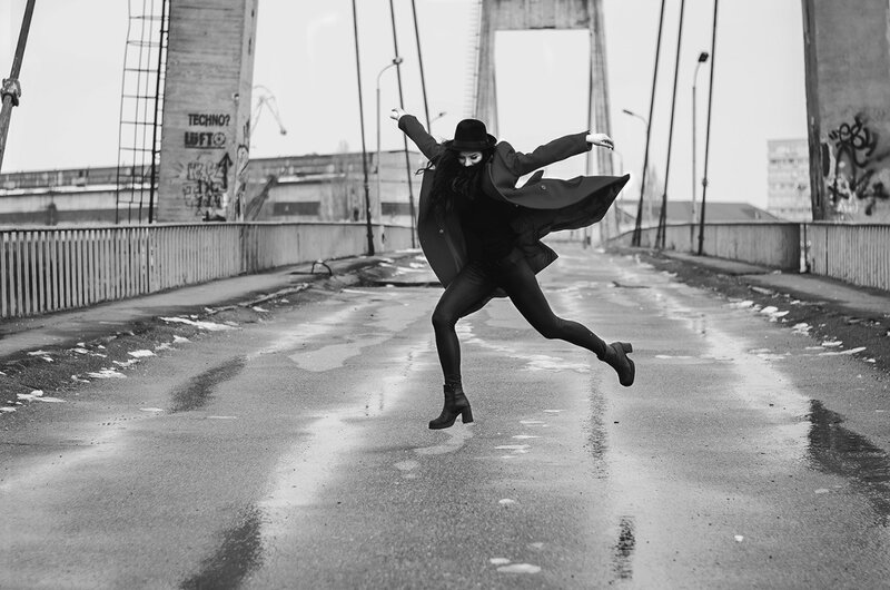 Person Jumping on Bridge