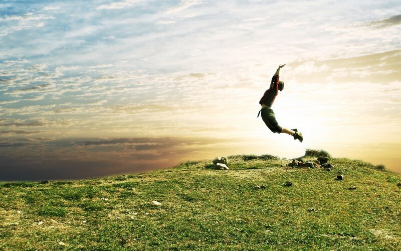 Person Jumping on Hill — Green, Dramatic, Sunset