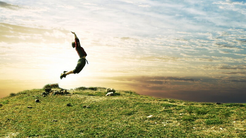 Person Jumping on Hill