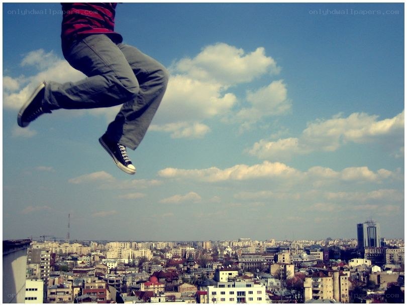 person jumping over city