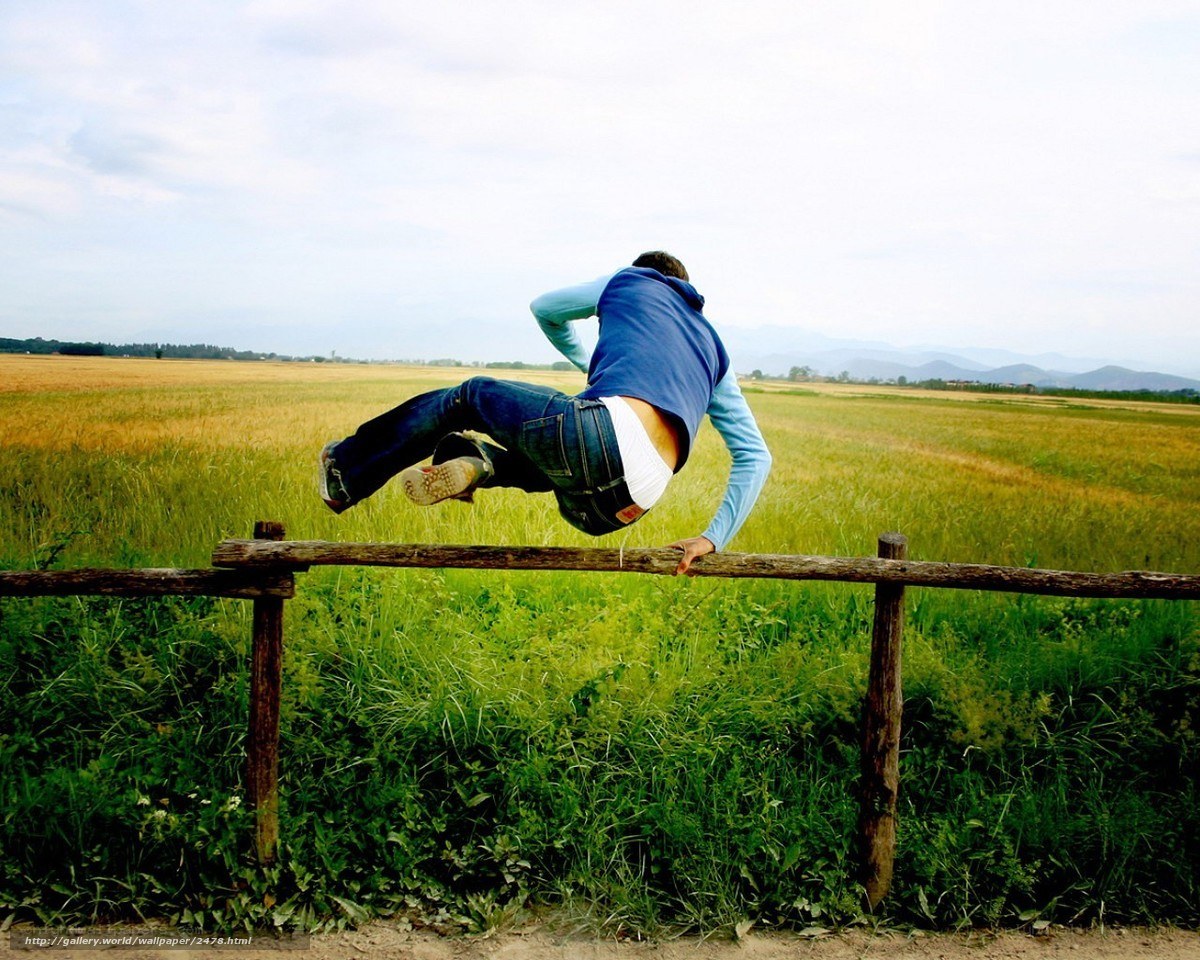 Person jumping over fence