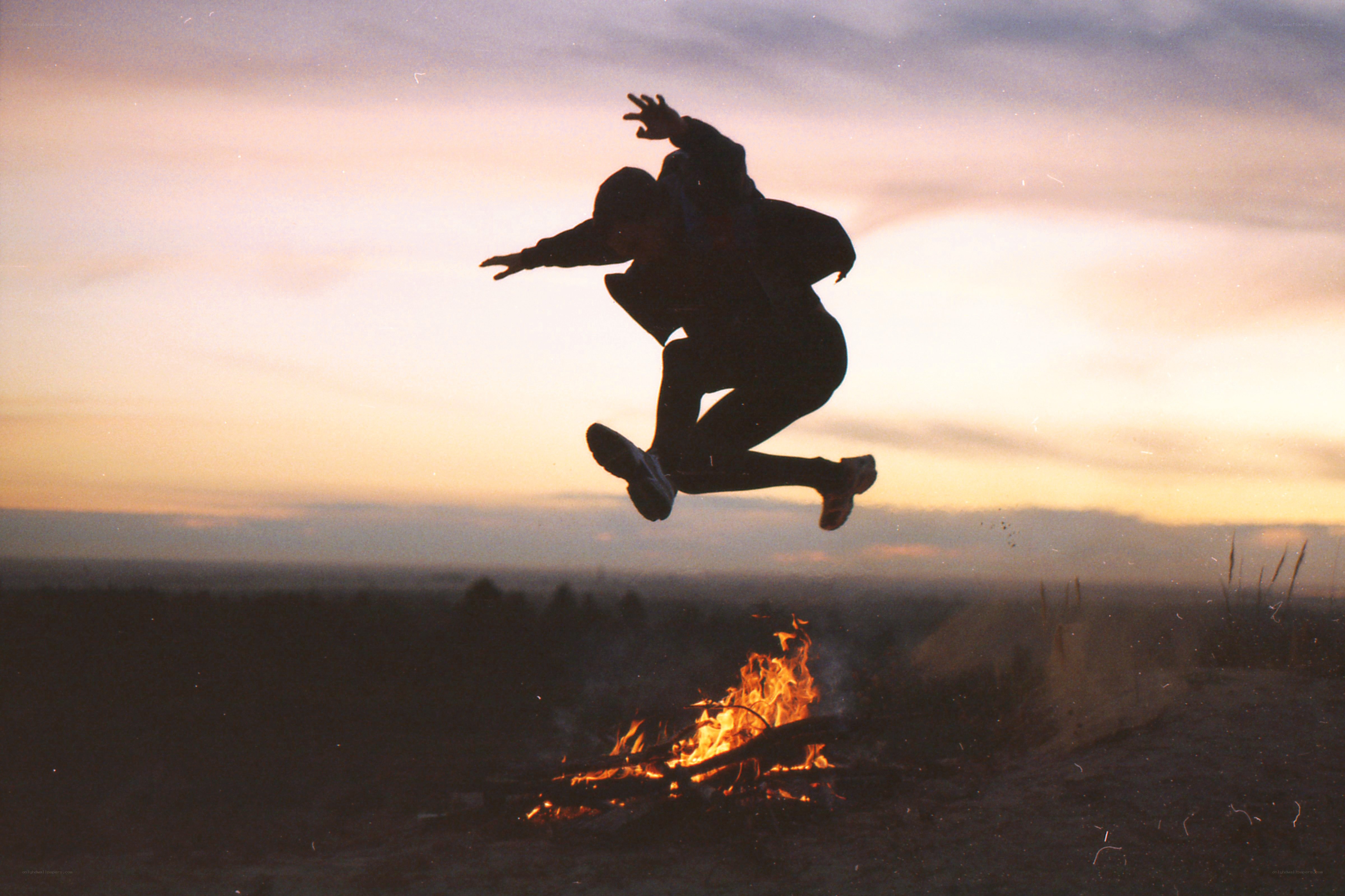 person jumping over fire