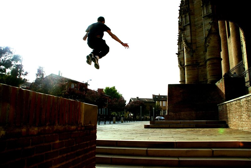 Person Jumping over Wall