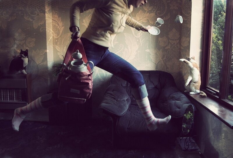 Person jumping with tea set