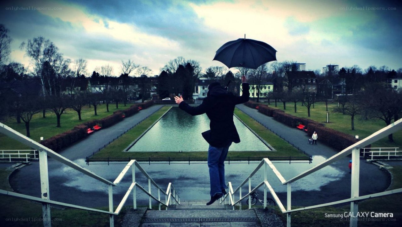 Person jumping with umbrella