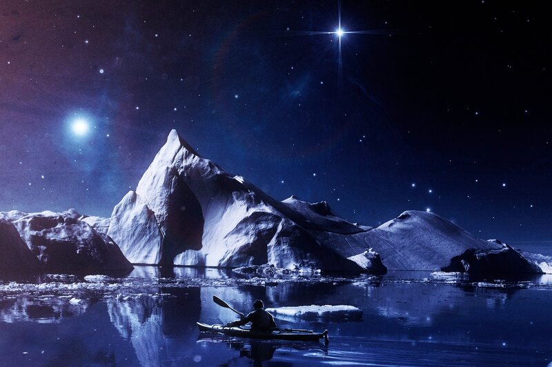 Person Kayaking Near Iceberg