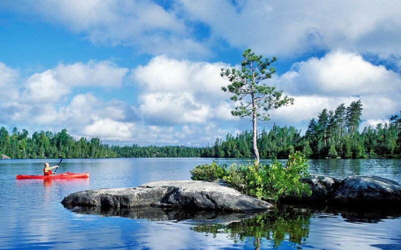 Person Kayaking on Lake — Blue