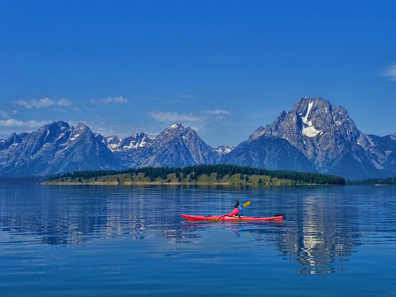 Person Kayaking on Lake