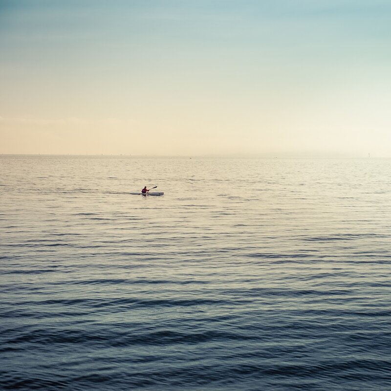 Person Kayaking on Water — Blue