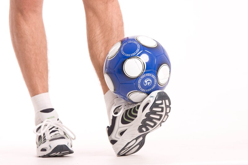 person kicking a soccer ball