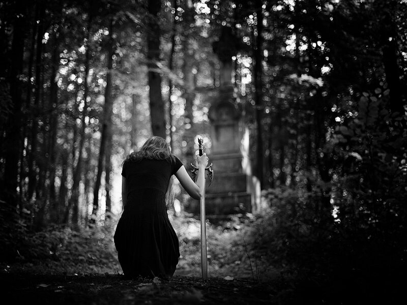 Person Kneeling in Forest