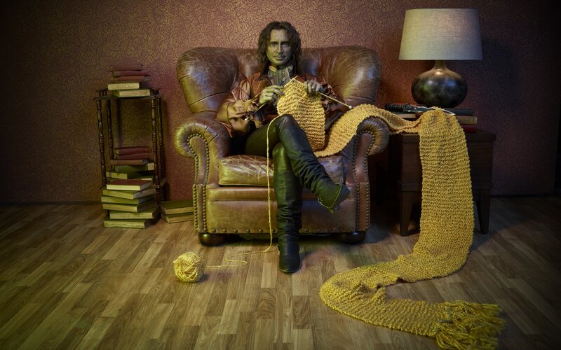 Person Knitting in Armchair